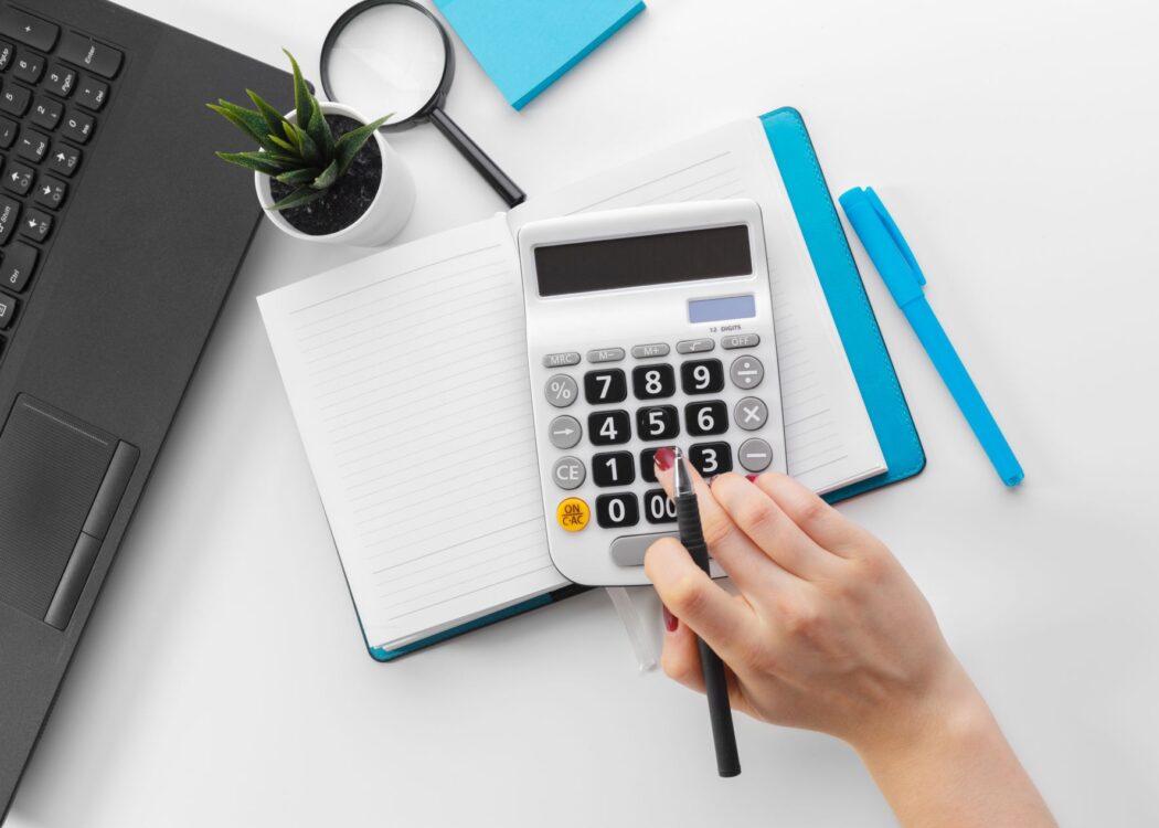 Business woman working with financial data hand using calculator